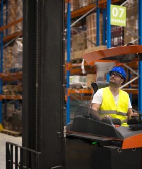 forklift-driver-relocating-lifting-goods-large-warehouse-center